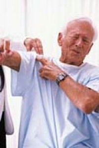 Man whincing as he lifts his arm